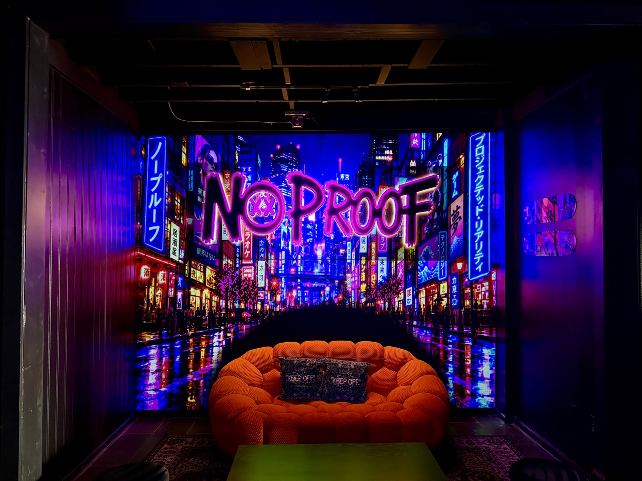 Neon city visuals behind the No Proof lounge seating